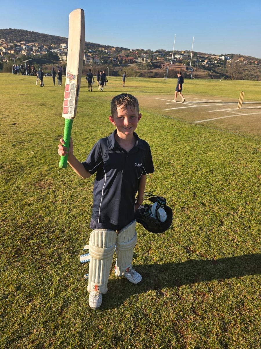 Junior raising his bat after a fifty